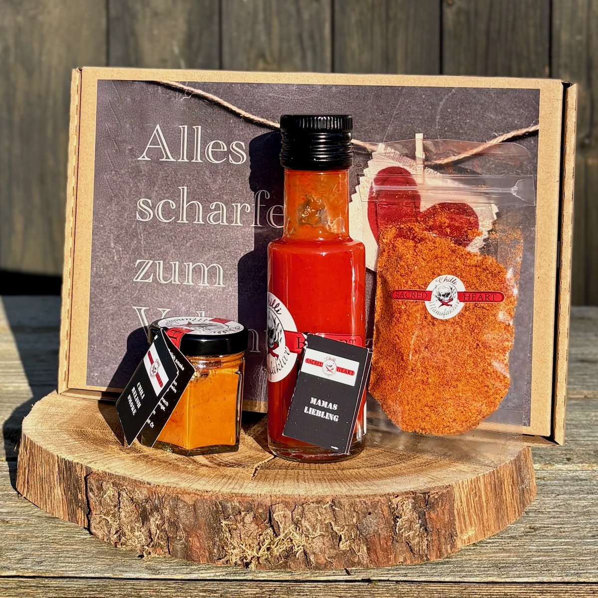 Valentinstag-Geschenk-Mannannen mit geräuchterter Chilipaste Chilipulver und Chilisauce in einer Geschenkbox mit der Beschriftung alles scharfe zum Valentinstag