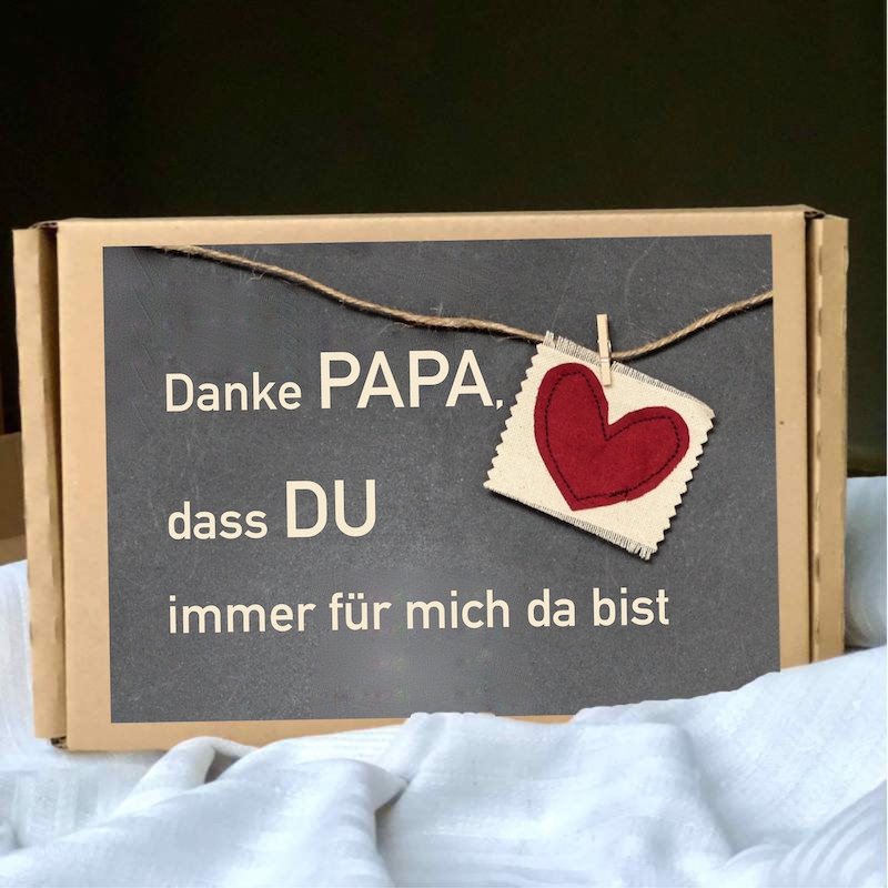 Geschenke zum Vatertag hier eine Geschenkbox mit der Beschriftung Danke Papa, dass DU immer für mich da bist und einem roten Herz auf grauen Untergrund